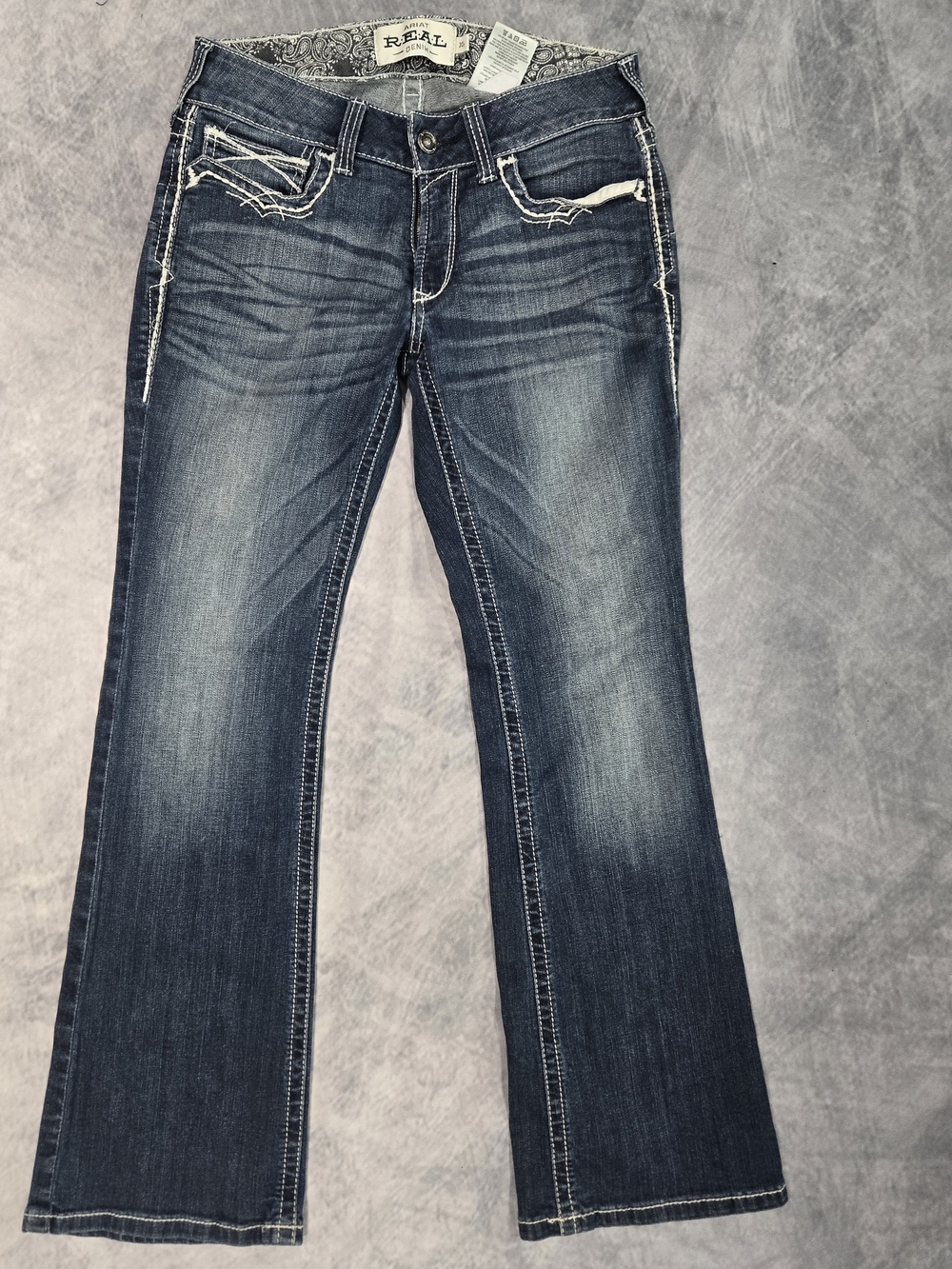 Ariat Women's R.E.A.L. Mid Rise Stretch Entwined Boot Cut Jeans.